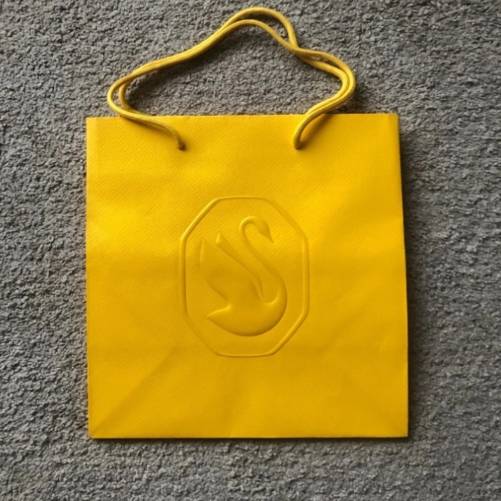 Swarovski Yellow Paper Bag with Embossed Swan Logo.